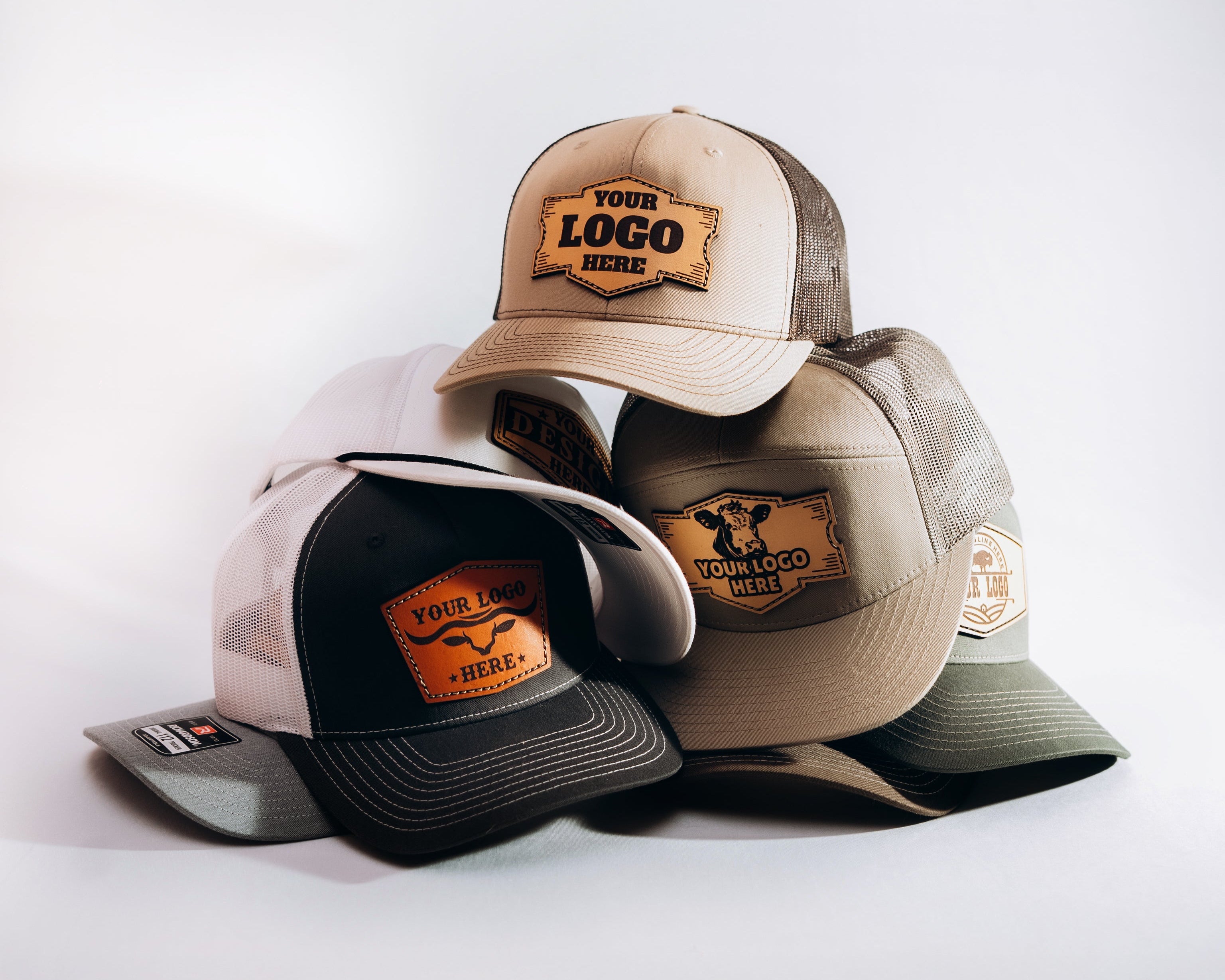 Custom leather patch hats with branded patches on a white background