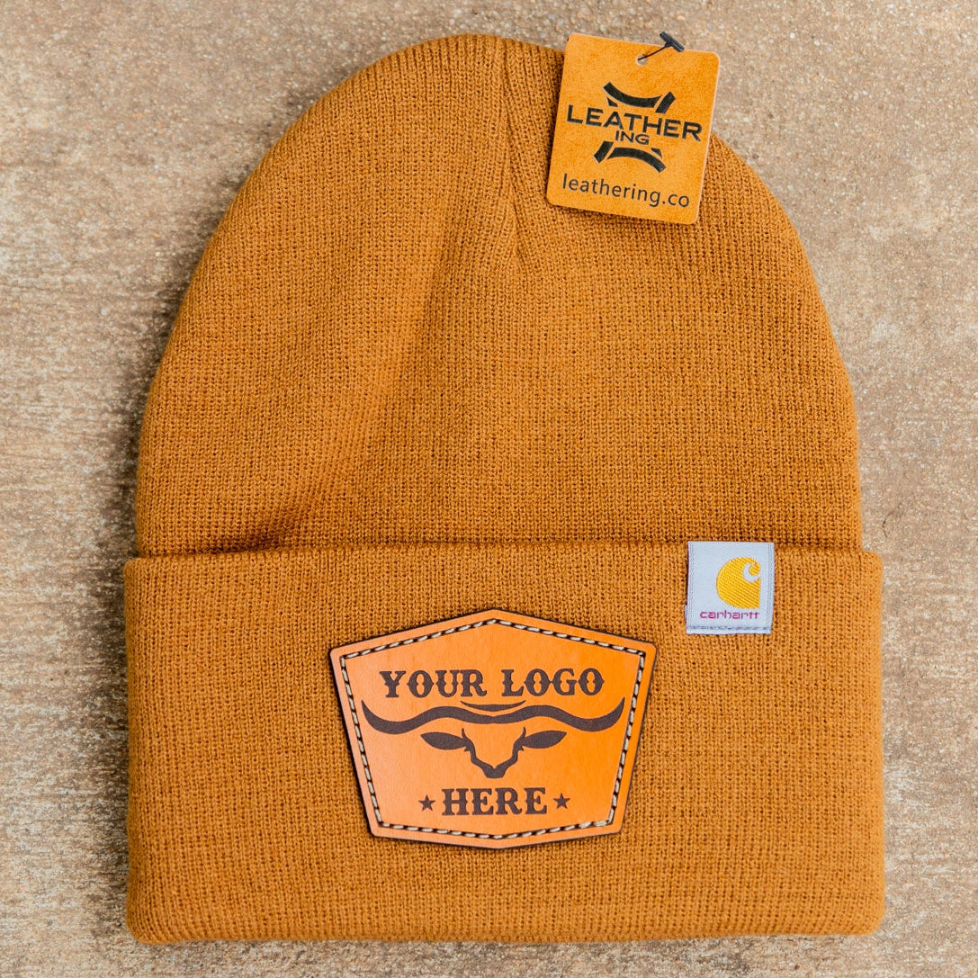 Yellow beanie with leather patch on a beige background