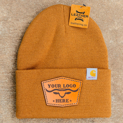 Yellow beanie with leather patch on a beige background
