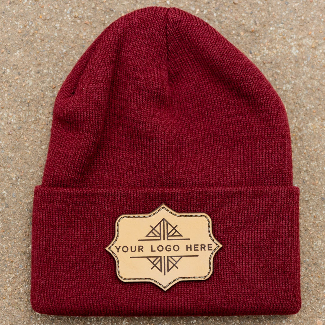 Red beanie with a leather patch on a beige background