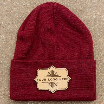 Red beanie with a leather patch on a beige background